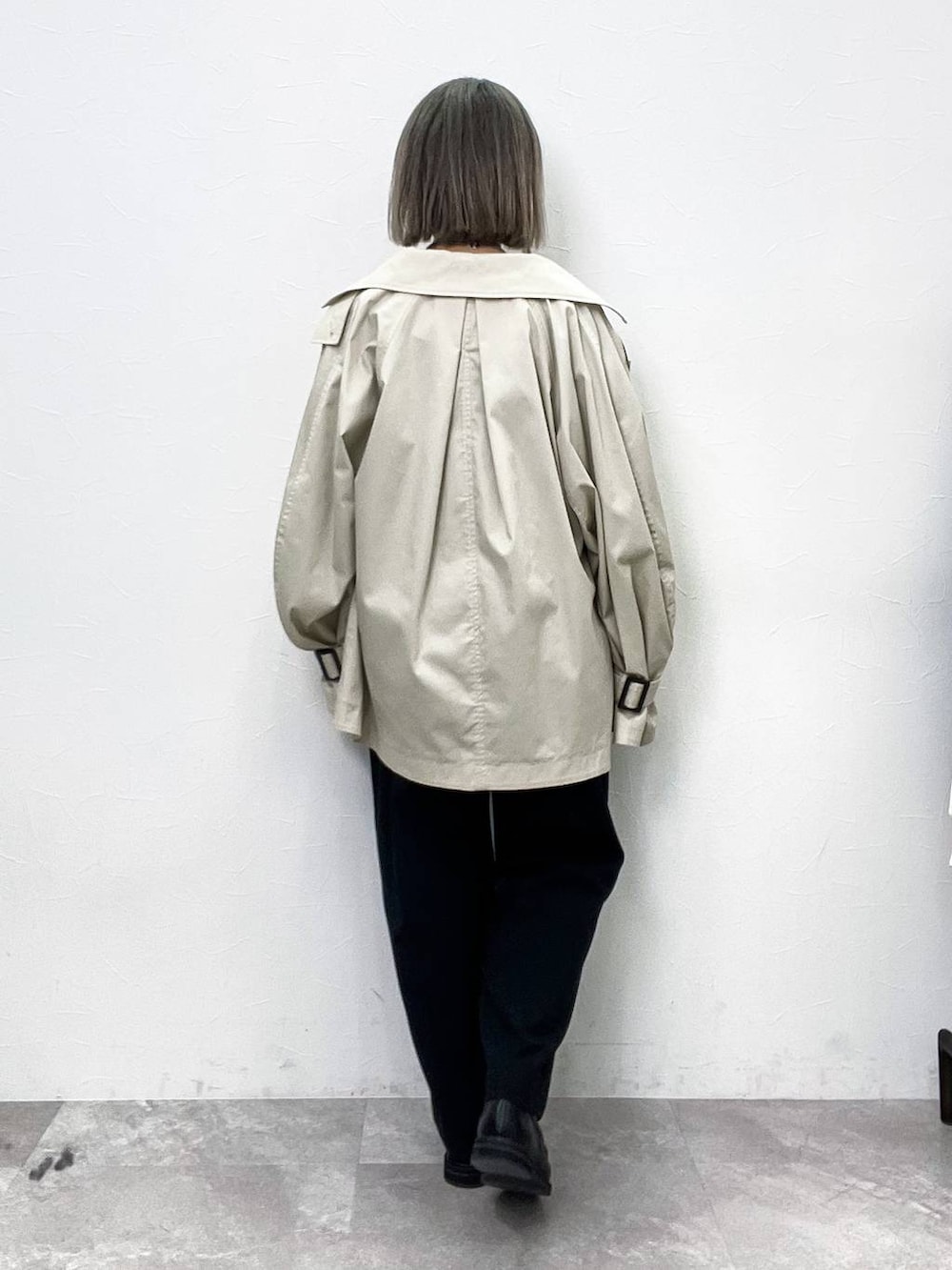 ブラック系のローファー、ベージュ系のトレンチコート、ブラック系のその他パンツを着用したレディースの春コーディネートの4枚目の写真