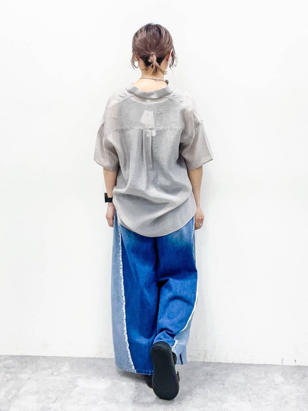 グレー系のシャツ/ブラウス、グレー系のタンクトップ、ブルー系のデニムパンツを着用したレディースの夏コーディネートの4枚目の写真