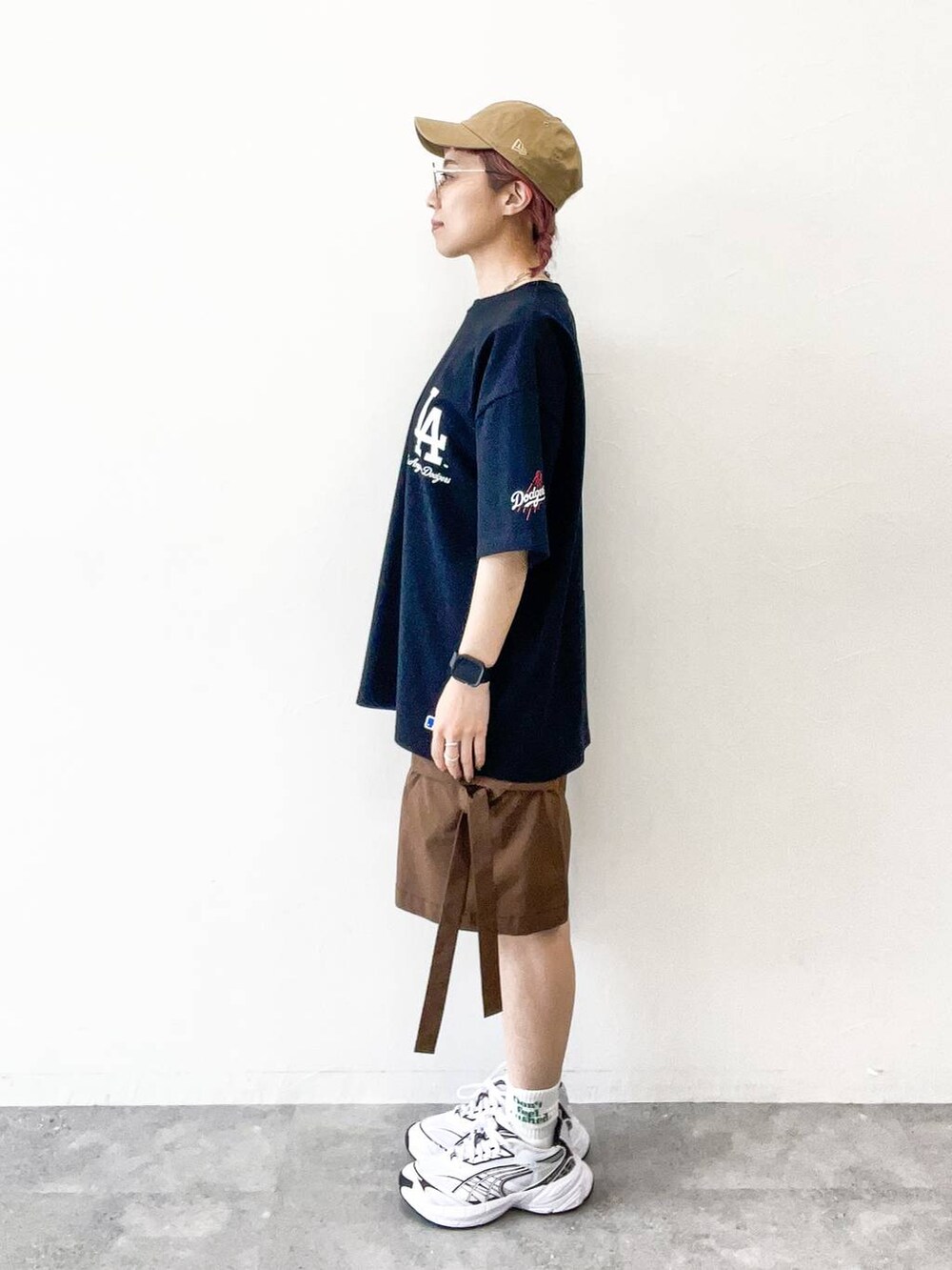 ブラウン系のカーゴパンツ、ブラック系のTシャツ/カットソー、ベージュ系のキャップを着用したレディースの夏コーディネートの3枚目の写真