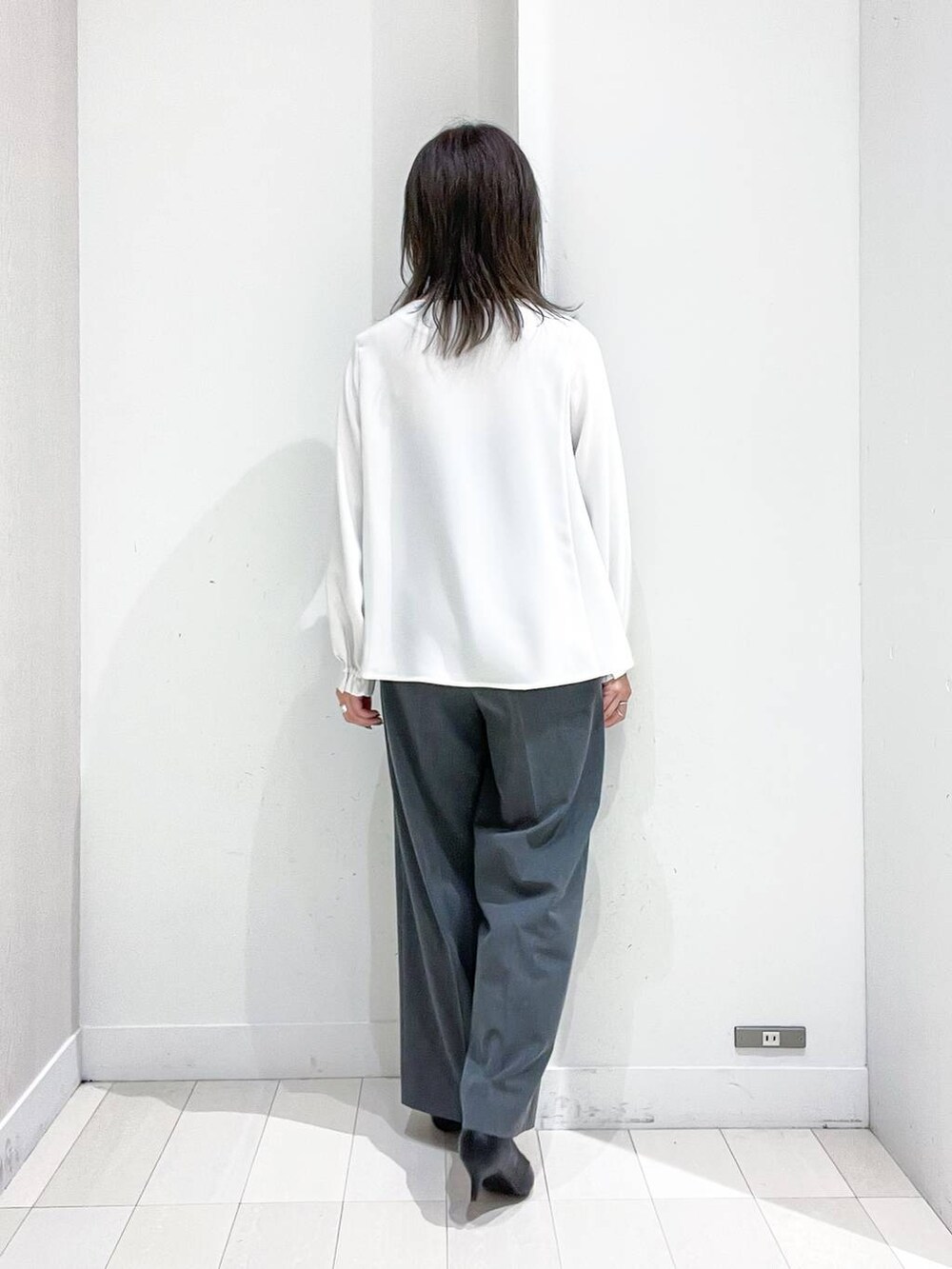 ブラック系のパンプス、ホワイト系のノーカラージャケット、ホワイト系のシャツ/ブラウスを着用したレディースの冬コーディネートの8枚目の写真