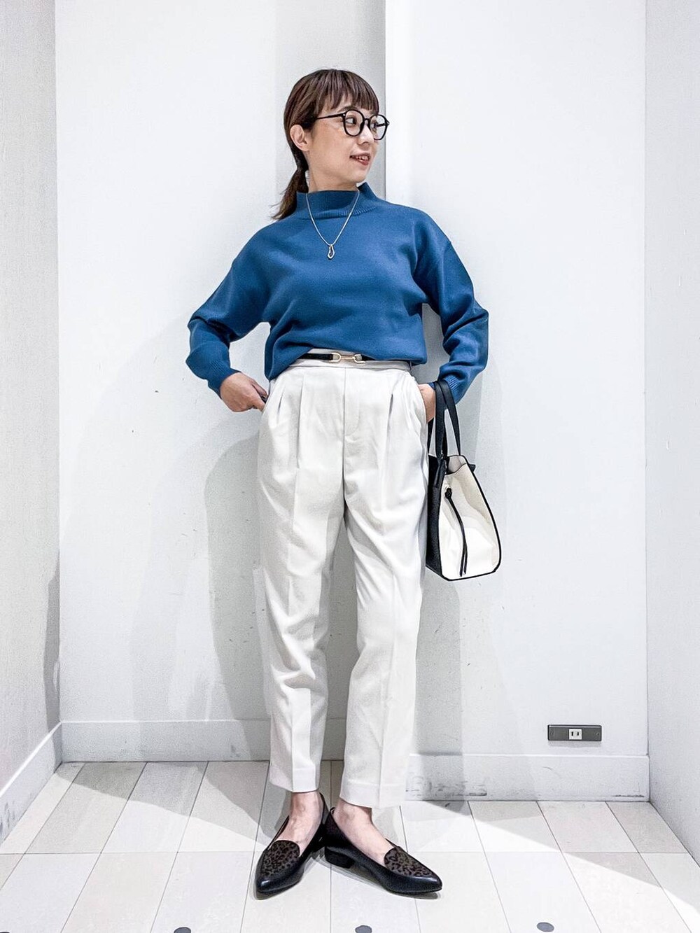 ブラック系のショルダーバッグ、その他のパンプス、ブルー系のニット/セーターを着用したレディースの秋コーディネートの6枚目の写真