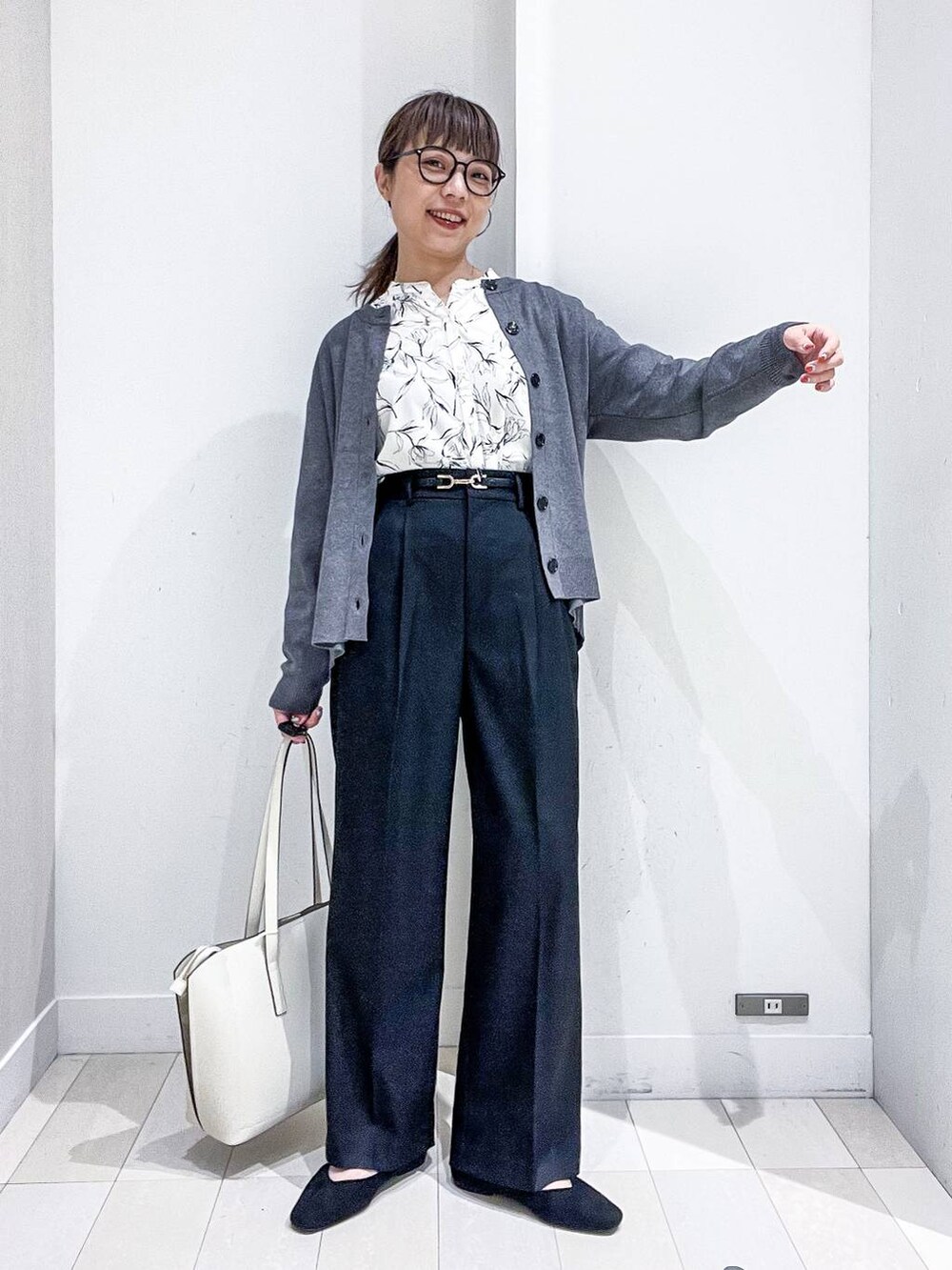 ブラック系のその他パンツ、ホワイト系のシャツ/ブラウス、グレー系のカーディガン/ボレロを着用したレディースの秋コーディネートの2枚目の写真