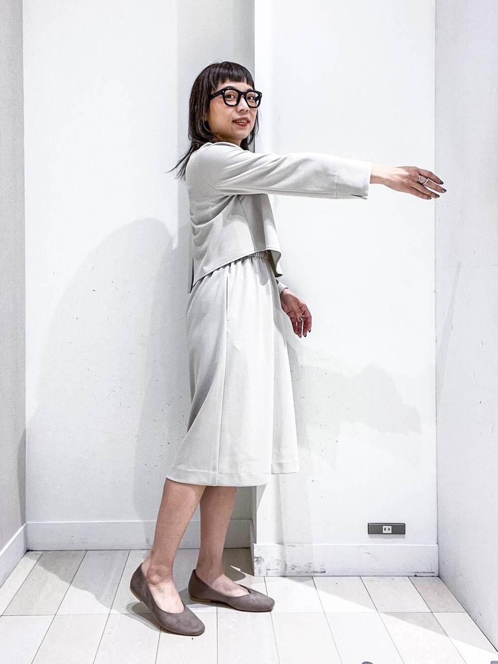 ベージュ系のパンプス、ホワイト系のノーカラージャケット、ベージュ系のワンピースを着用したレディースの冬コーディネートの9枚目の写真