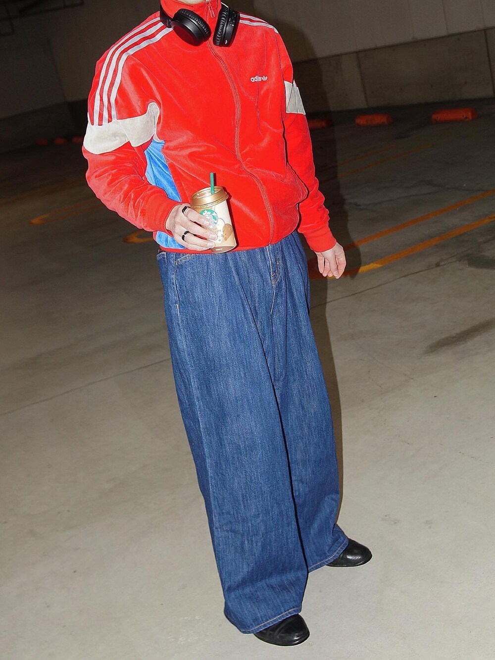 レッド系のジャージ、ブルー系のデニムパンツを着用したメンズの冬コーディネートの3枚目の写真