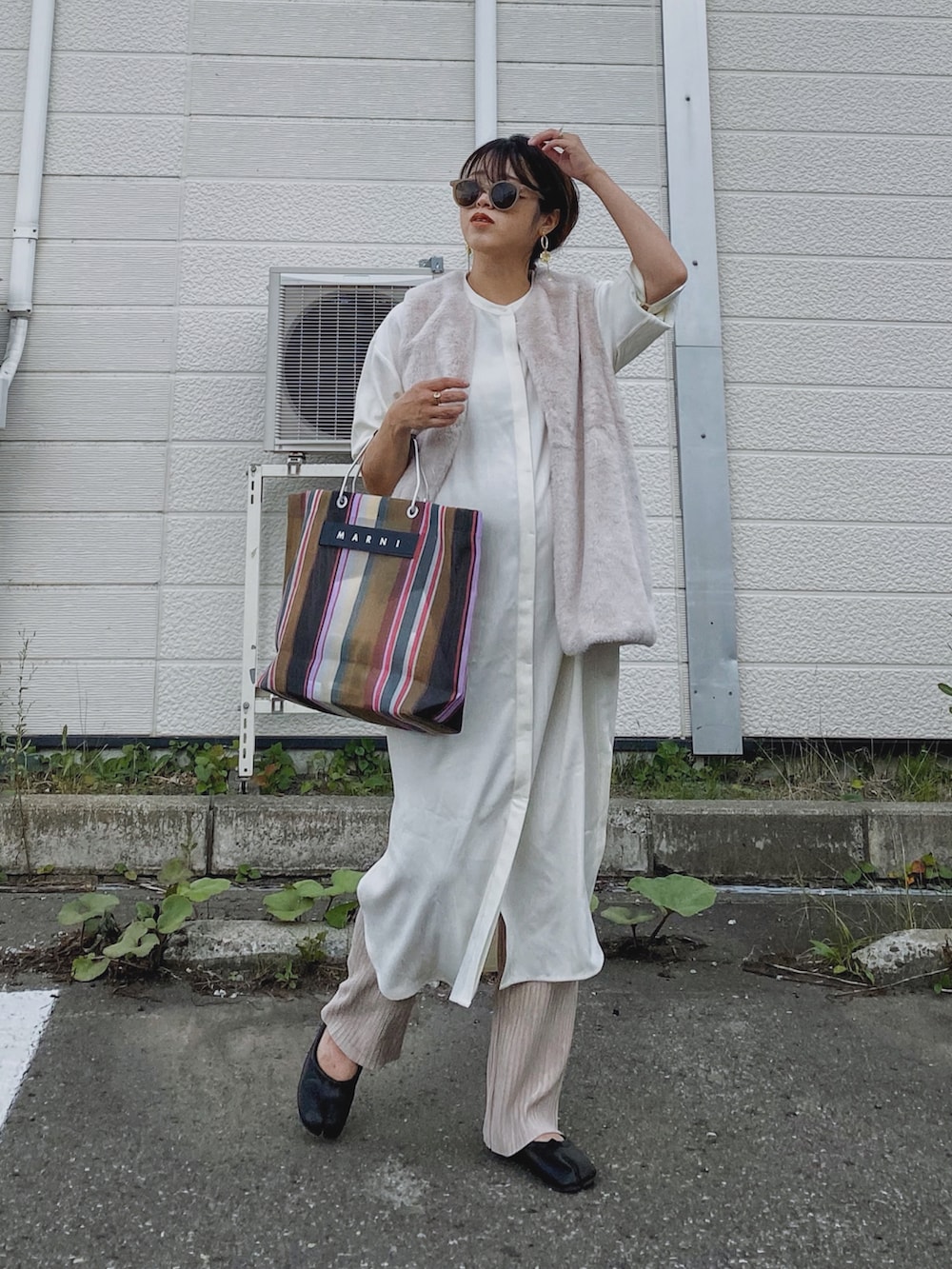 ブラック系のワンピース、ブラウン系のトートバッグ、ベージュ系のその他パンツを着用したレディースの秋コーディネートの4枚目の写真