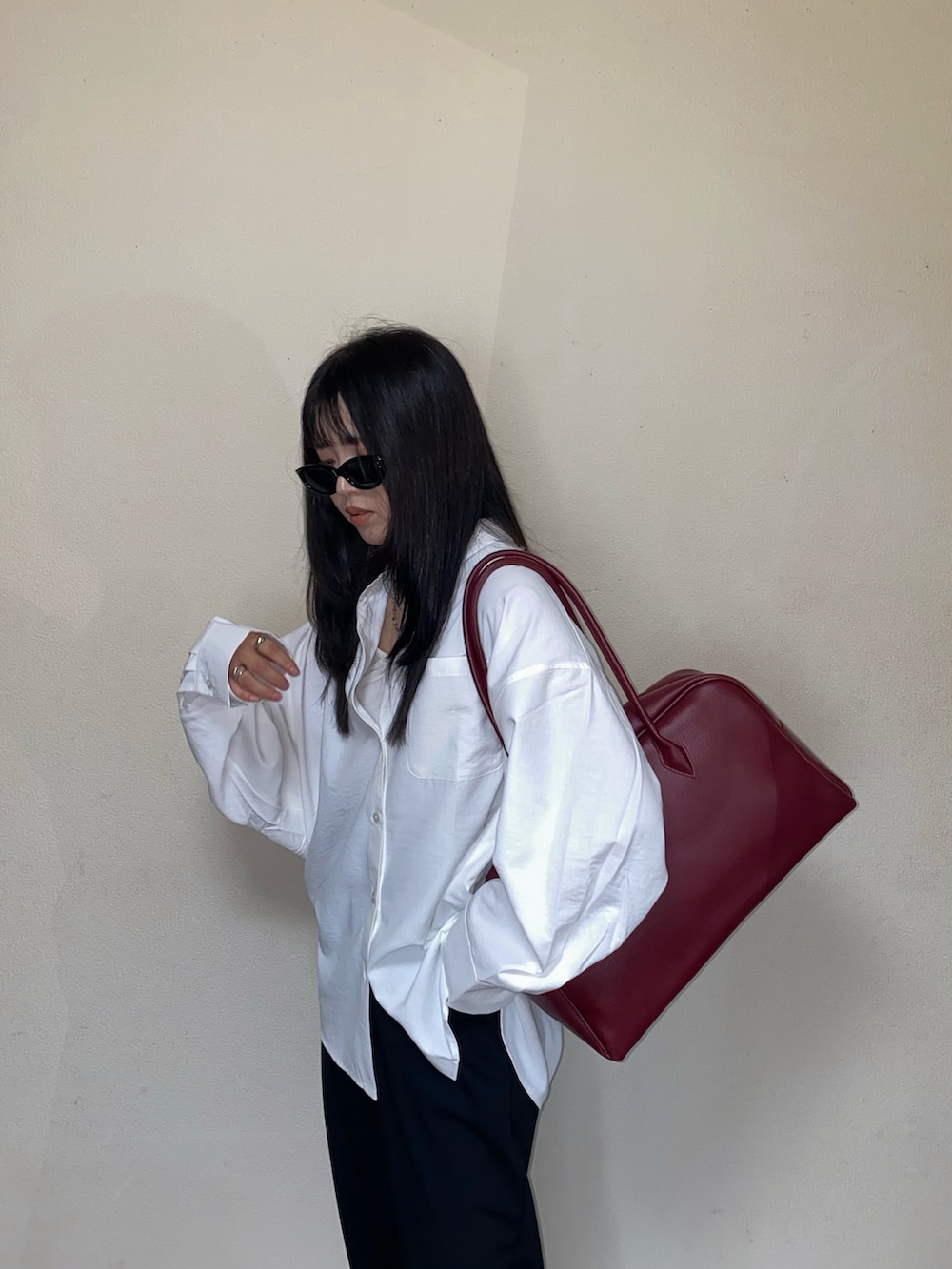 ホワイト系のシャツ/ブラウス、レッド系のボストンバッグ、レッド系のスニーカーを着用したレディースの秋コーディネートの5枚目の写真