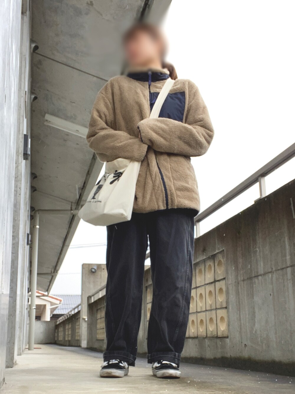 ベージュ系のジャケット/アウター、ベージュ系のバッグ、ブラック系のデニムパンツを着用したレディースの冬コーディネートの2枚目の写真