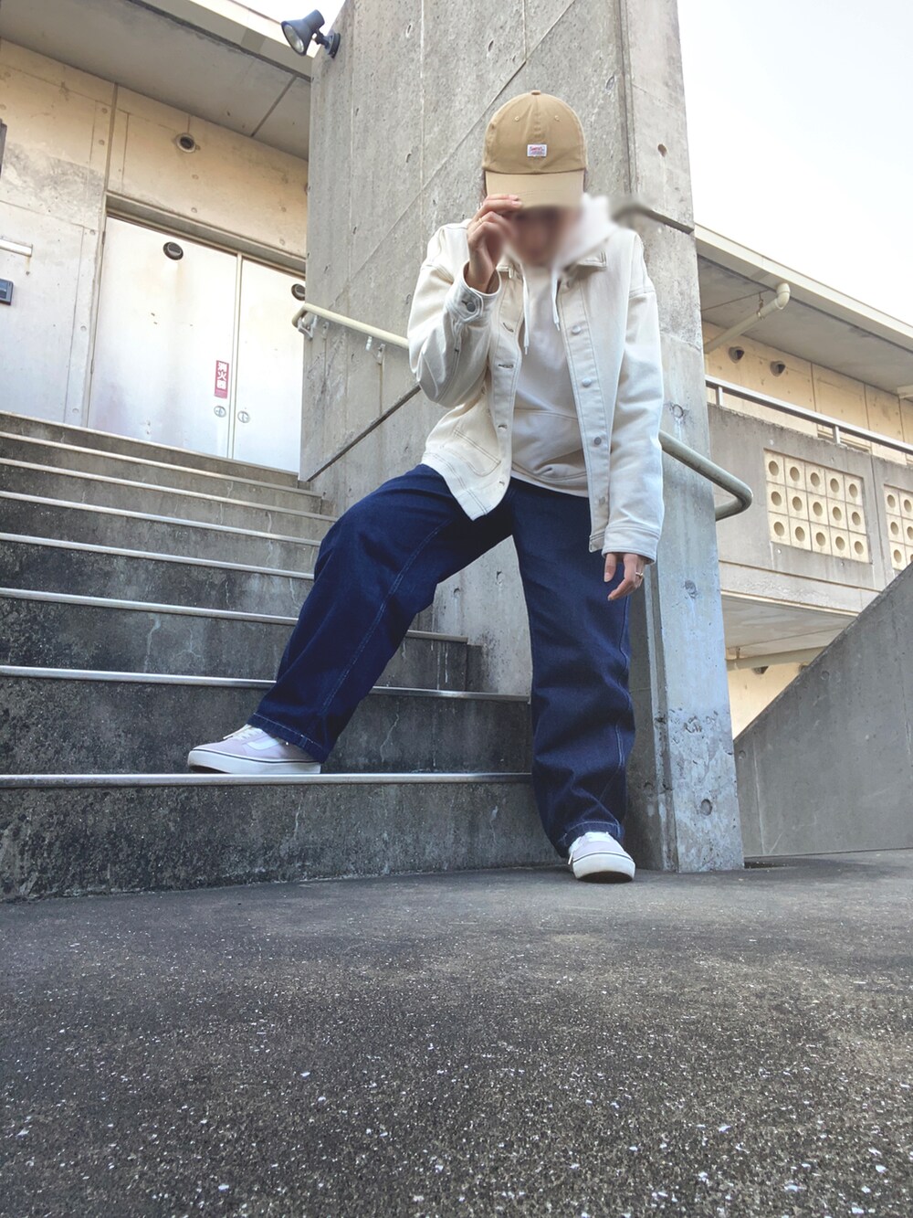 ブルー系のデニムパンツ、ホワイト系のパーカー、パープル系のスニーカーを着用したレディースの秋コーディネートの2枚目の写真