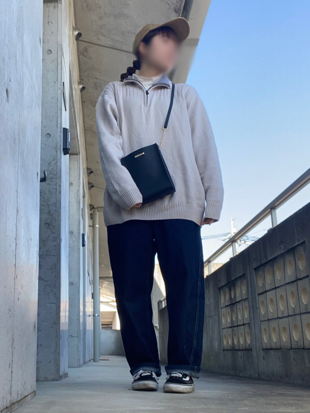 ブラック系のショルダーバッグ、ホワイト系のTシャツ/カットソー、ブルー系のデニムパンツを着用したレディースの春コーディネートの2枚目の写真