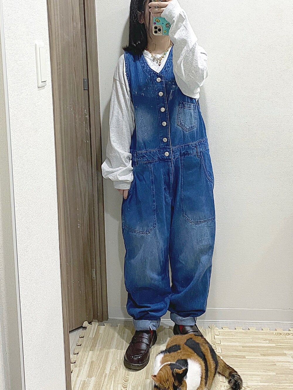 グレー系のTシャツ/カットソー、ブルー系のサロペット/オーバーオール、ブラウン系のローファーを着用したレディースの秋コーディネートの2枚目の写真