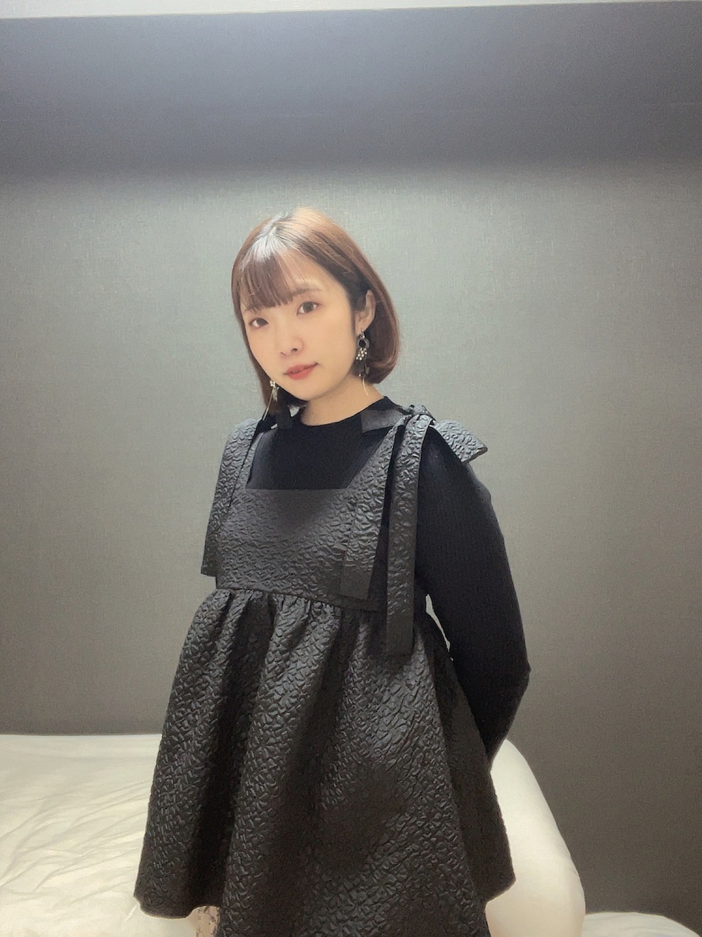 ブラック系のTシャツ/カットソー、ブラック系のニット/セーター、シルバー系のピアス（両耳用）を着用したレディースの冬コーディネートの2枚目の写真