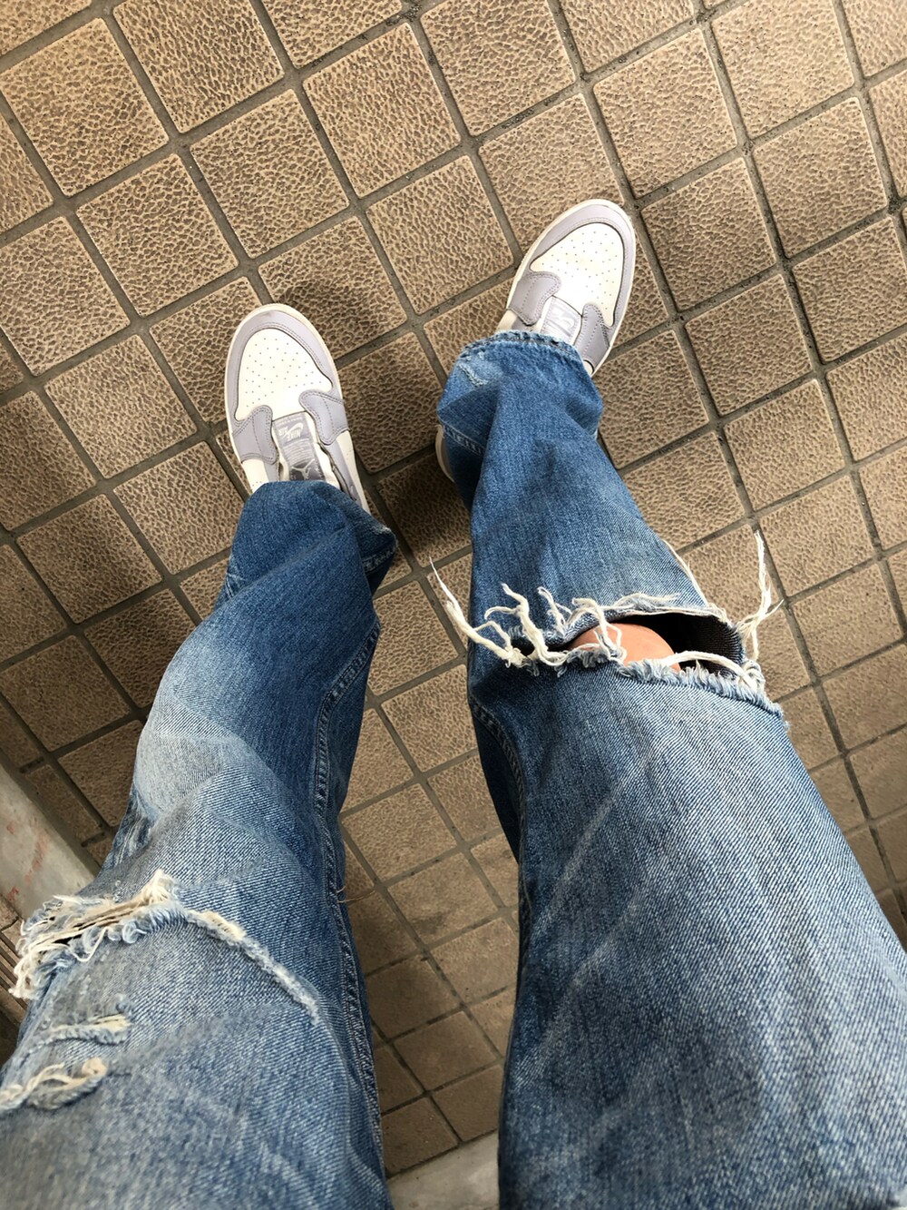 ブルー系のデニムパンツ、ブラック系のTシャツ/カットソー、グレー系のスニーカーを着用したレディースの春コーディネートの4枚目の写真