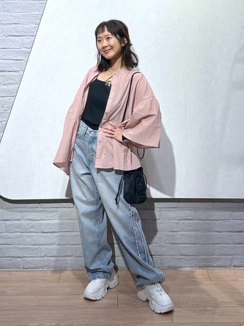 ピンク系のシャツ/ブラウス、ホワイト系のスニーカー、ブラック系のキャミソールを着用したレディースの秋コーディネートの5枚目の写真