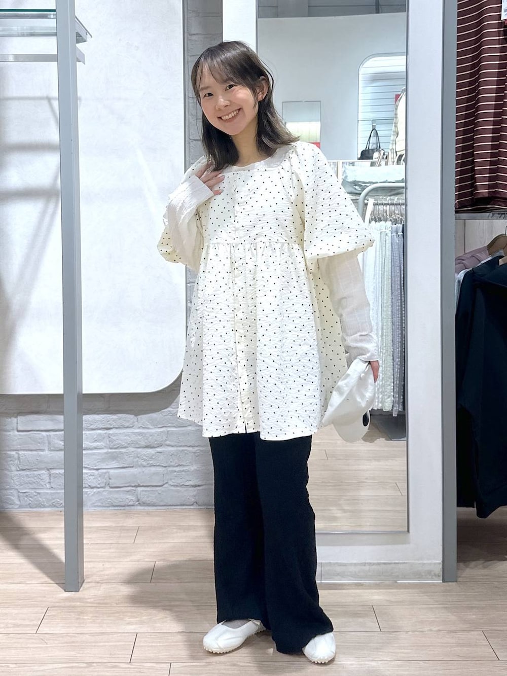 ベージュ系のTシャツ/カットソー、ホワイト系のスニーカー、ブラック系のその他パンツを着用したレディースの春コーディネートの4枚目の写真