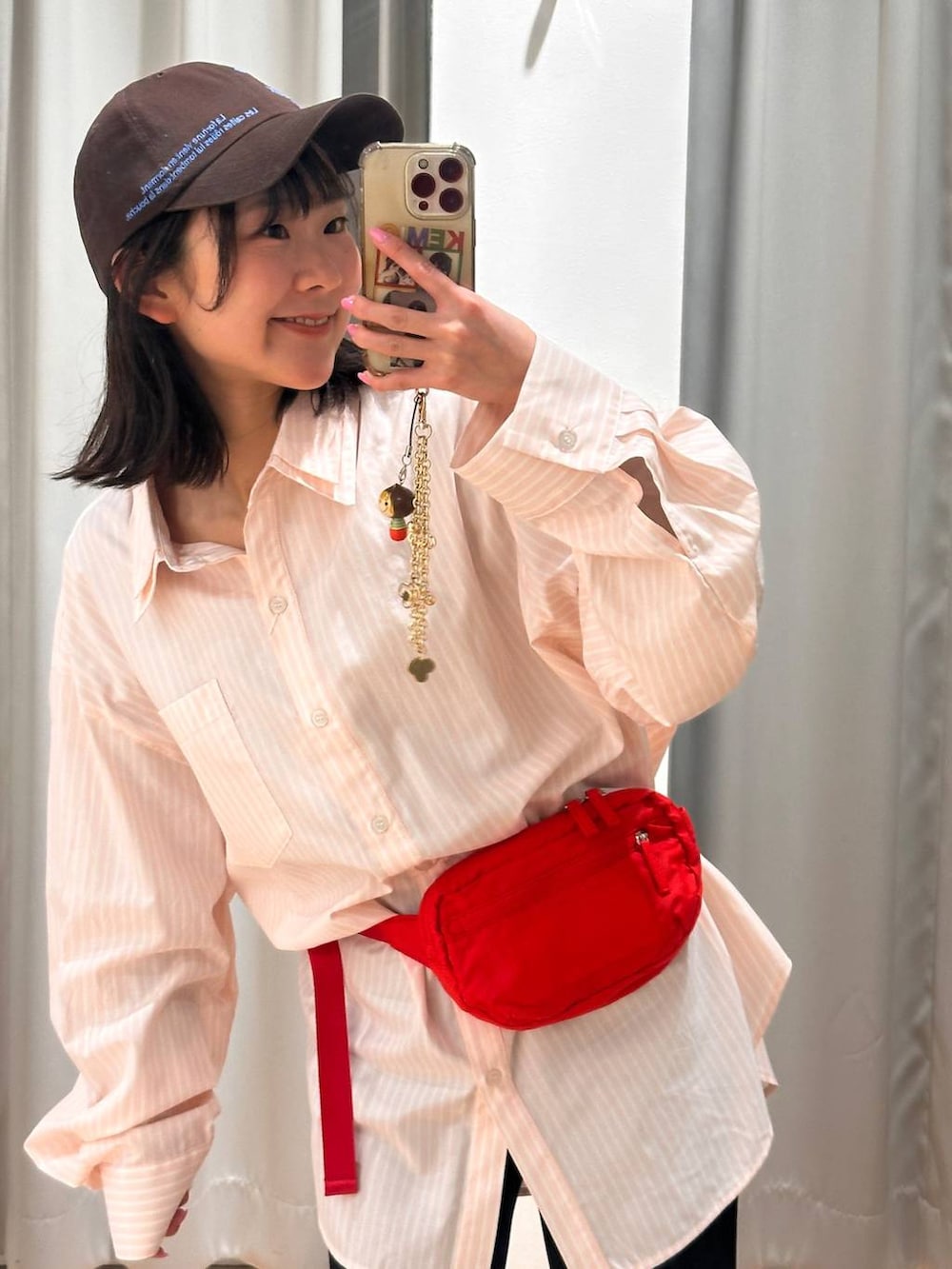 レッド系のボディバッグ/ウエストポーチ、ピンク系のシャツ/ブラウス、ブラック系のその他パンツを着用したレディースの春コーディネートの4枚目の写真