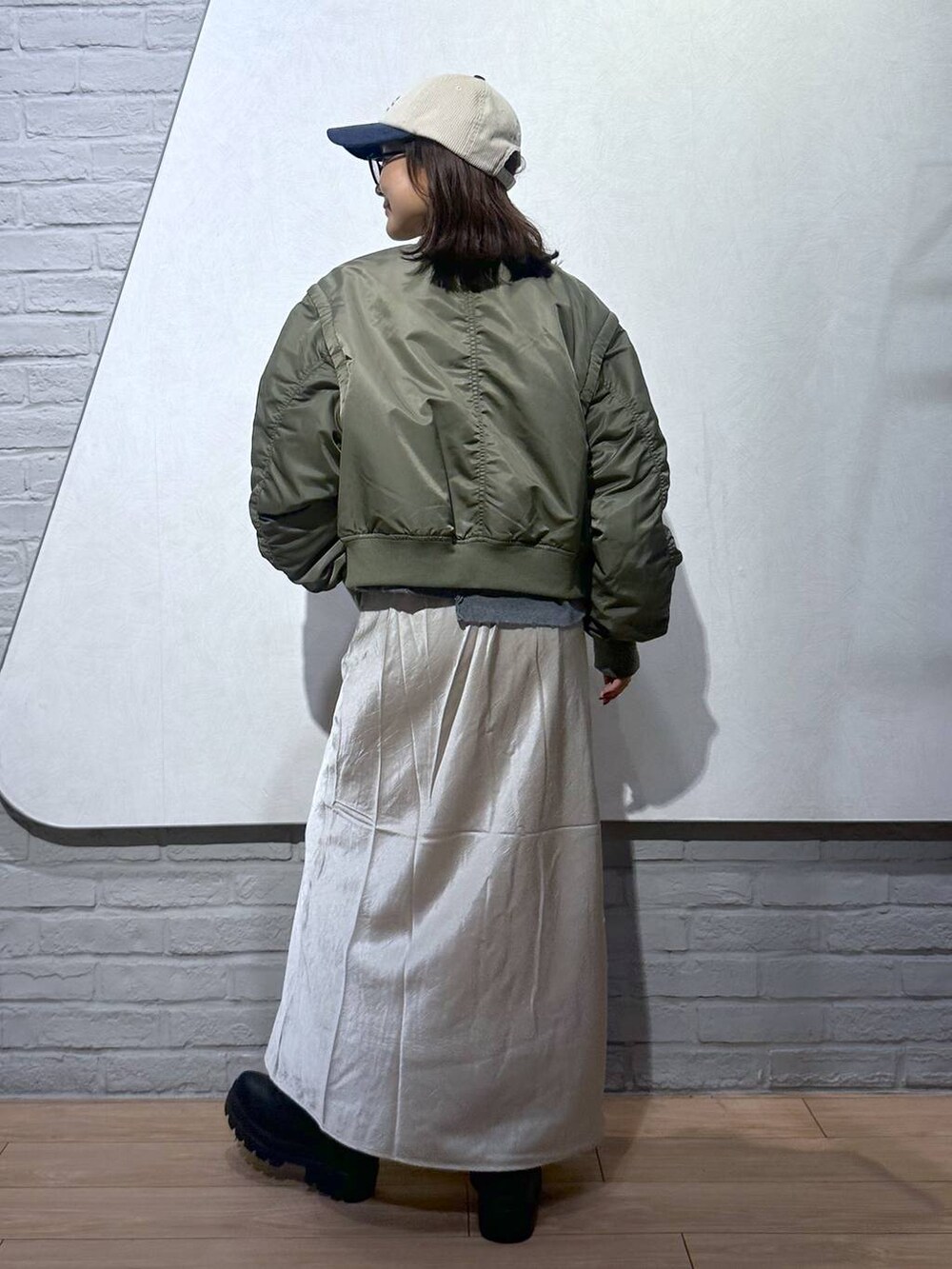 ブラック系のブーツ、ホワイト系のスカート、グレー系のスウェットを着用したレディースの秋コーディネートの4枚目の写真