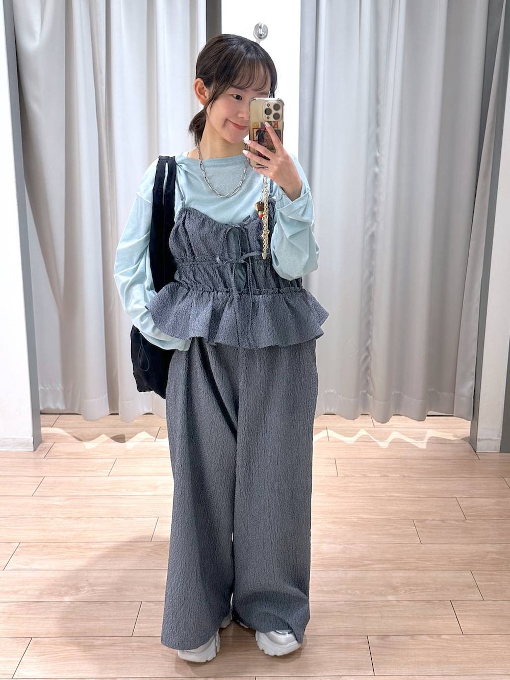 グリーン系のTシャツ/カットソー、ブラック系のトートバッグ、ブルー系のサロペット/オーバーオールを着用したレディースの春コーディネートの2枚目の写真