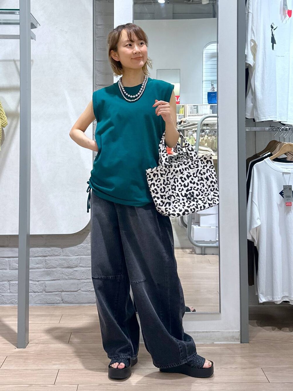 ブラック系のサンダル、ブラック系のデニムパンツ、その他のショルダーバッグを着用したレディースの夏コーディネートの5枚目の写真