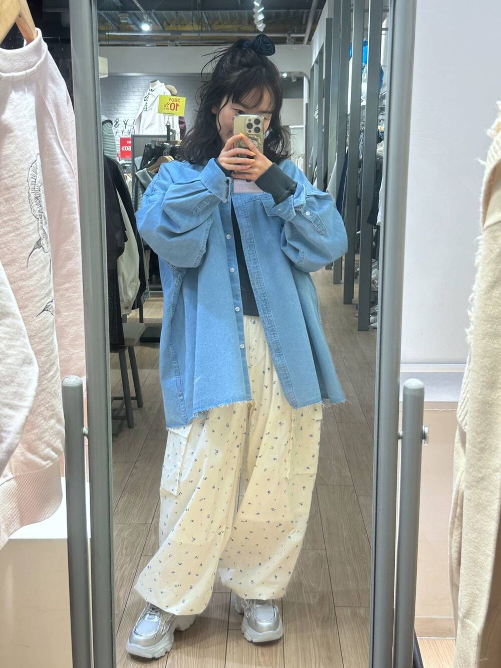 ホワイト系のカーゴパンツ、シルバー系のスニーカー、ブラック系のスウェットを着用したレディースの冬コーディネートの2枚目の写真