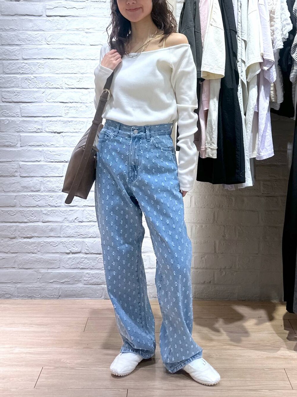 ブルー系のデニムパンツ、ホワイト系のTシャツ/カットソー、ホワイト系のスニーカーを着用したレディースの春コーディネートの4枚目の写真