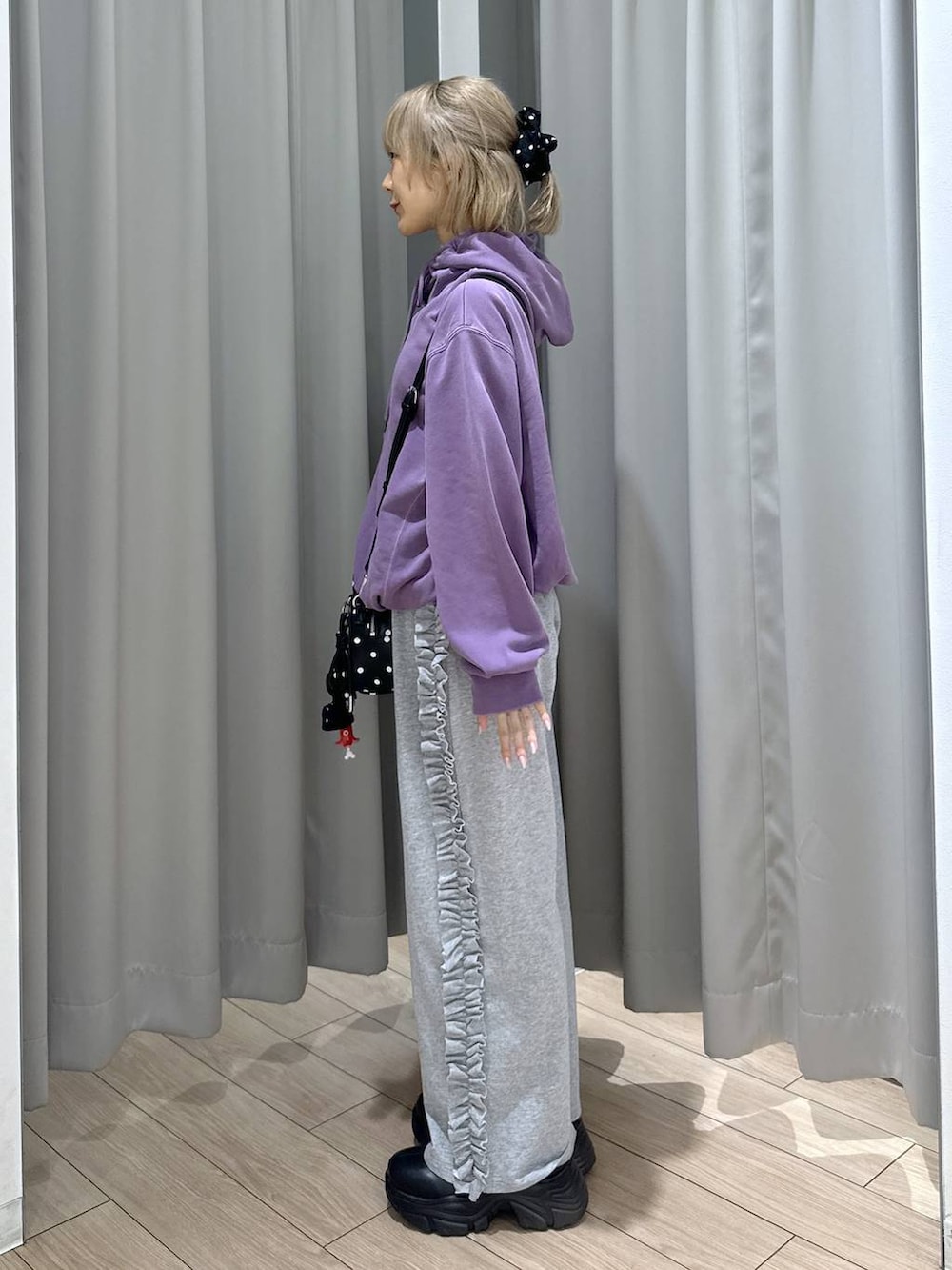 ブラック系のブーツ、パープル系のパーカー、その他のボストンバッグを着用したレディースの秋コーディネートの3枚目の写真