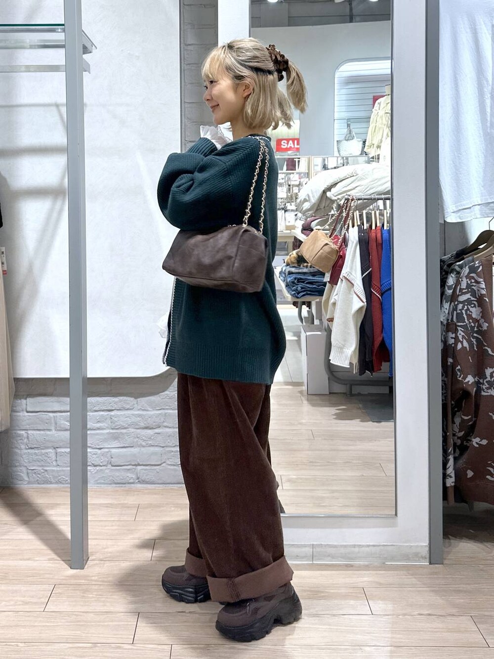 グリーン系のカーディガン/ボレロ、ブラウン系のその他パンツ、ホワイト系のTシャツ/カットソーを着用したレディースの秋コーディネートの3枚目の写真