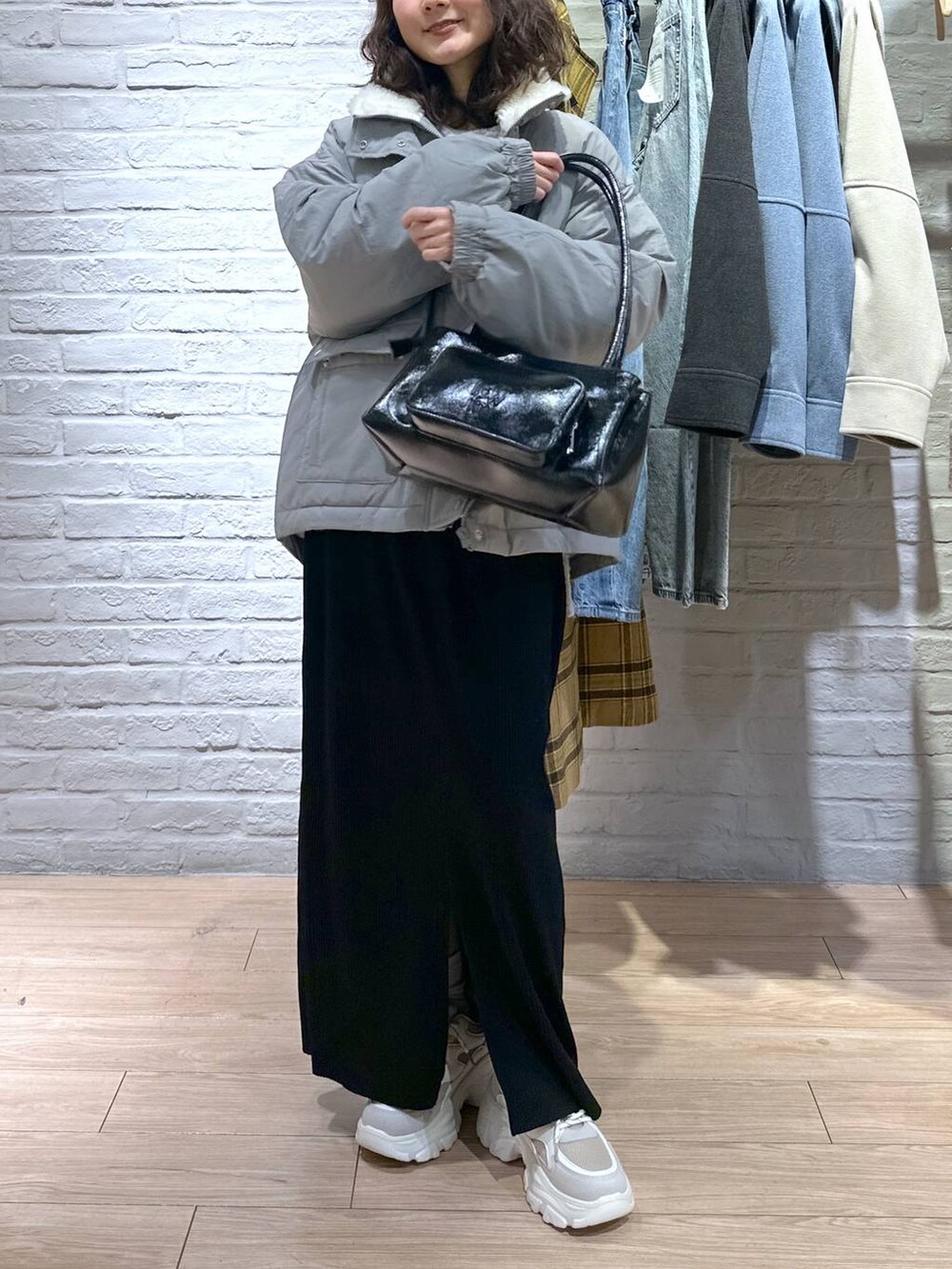 ブラック系のスカート、グリーン系のブルゾン、ベージュ系のスニーカーを着用したレディースの冬コーディネートの3枚目の写真