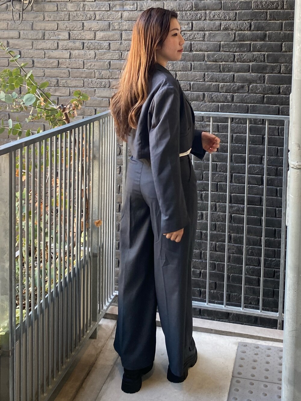 グレー系のテーラードジャケット、ホワイト系のTシャツ/カットソー、グレー系のその他パンツを着用したレディースの秋コーディネートの3枚目の写真
