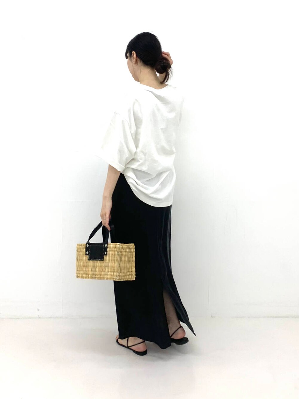 ブラック系のかごバッグ、ブラック系のスカート、その他のTシャツ/カットソーを着用したレディースの夏コーディネートの2枚目の写真