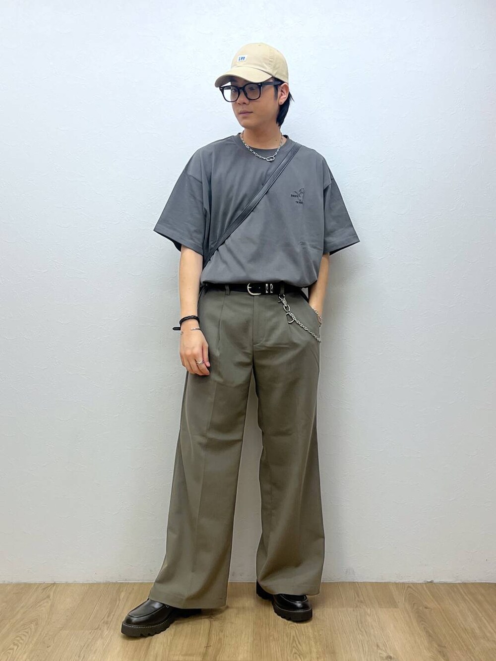 ブラック系のドレスシューズ、ベージュ系のスラックス、グレー系のTシャツ/カットソーを着用したメンズの春コーディネートの4枚目の写真