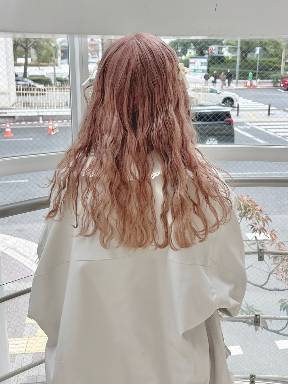 ホワイト系のブルゾン、グリーン系のTシャツ/カットソー、ピンク系のスウェットパンツを着用したレディースの冬コーディネートの6枚目の写真