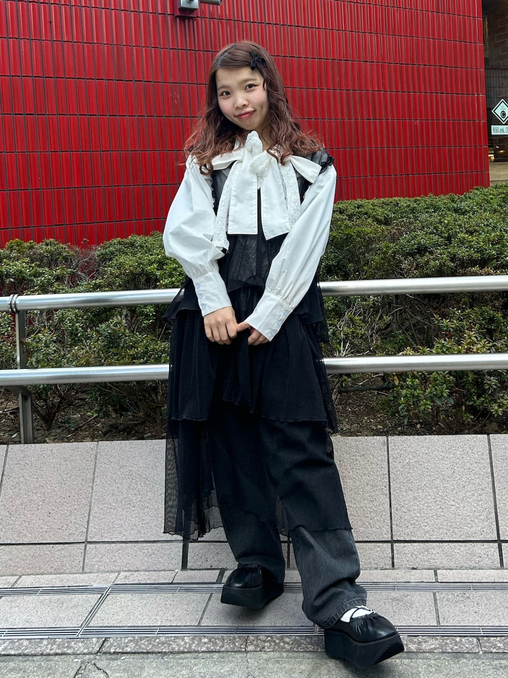 ホワイト系のシャツ/ブラウス、ブラック系のワンピース、ブラック系のデニムパンツを着用したレディースの冬コーディネートの2枚目の写真