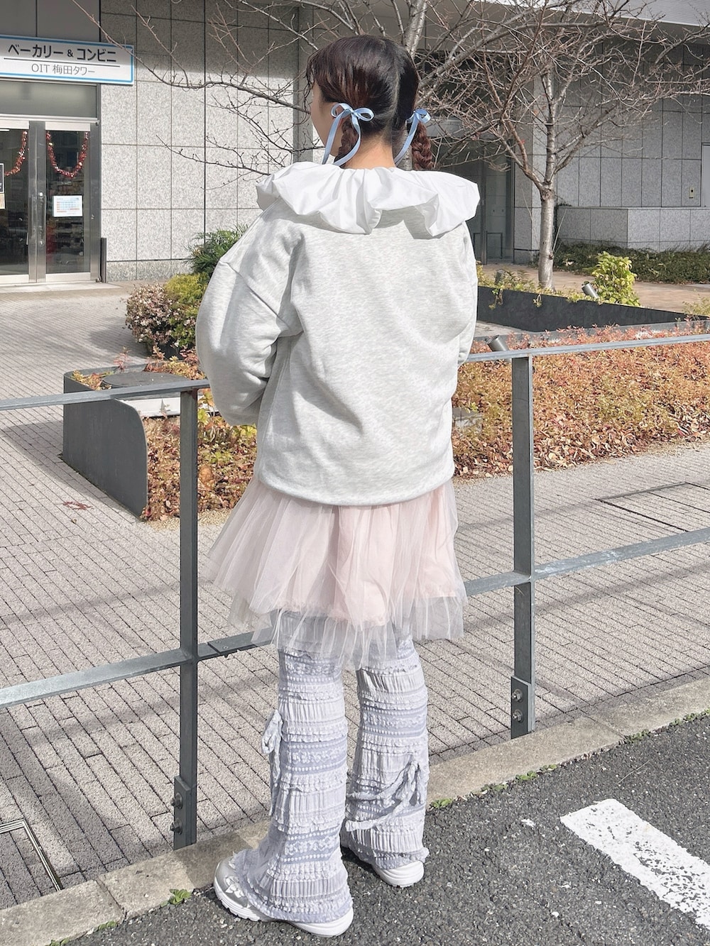 グレー系のスウェット、ピンク系のワンピース、ホワイト系のシャツ/ブラウスを着用したレディースの冬コーディネートの3枚目の写真