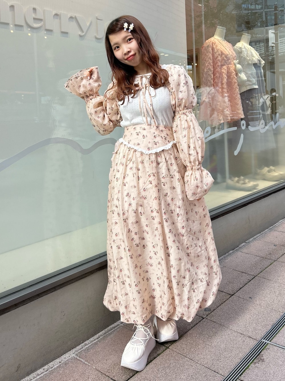 ピンク系のカーディガン/ボレロ、ホワイト系のTシャツ/カットソー、ピンク系のスカートを着用したレディースの春コーディネートの2枚目の写真