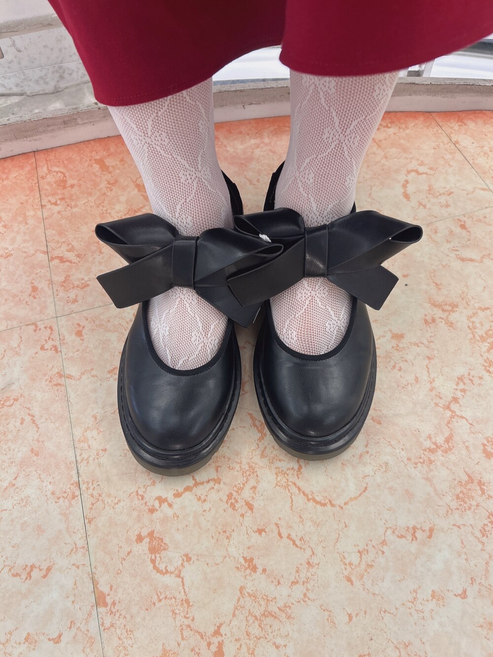 レッド系のワンピース、ゴールド系のシャツ/ブラウス、ブラック系のショルダーバッグを着用したレディースの秋コーディネートの10枚目の写真