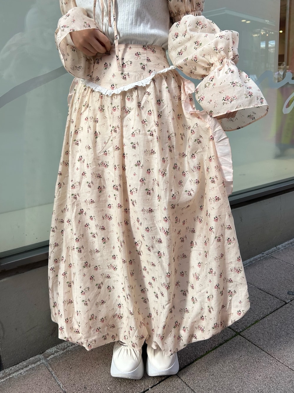 ピンク系のカーディガン/ボレロ、ホワイト系のTシャツ/カットソー、ピンク系のスカートを着用したレディースの春コーディネートの9枚目の写真