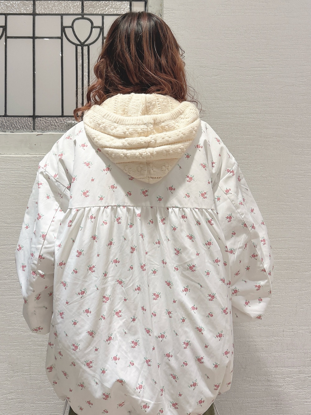 ピンク系のブルゾン、ホワイト系のニット/セーター、グリーン系のスカートを着用したレディースの秋コーディネートの6枚目の写真