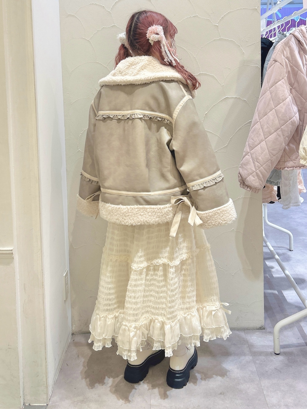 ホワイト系のシャツ/ブラウス、ホワイト系のベスト、ベージュ系のムートンコートを着用したレディースの冬コーディネートの4枚目の写真