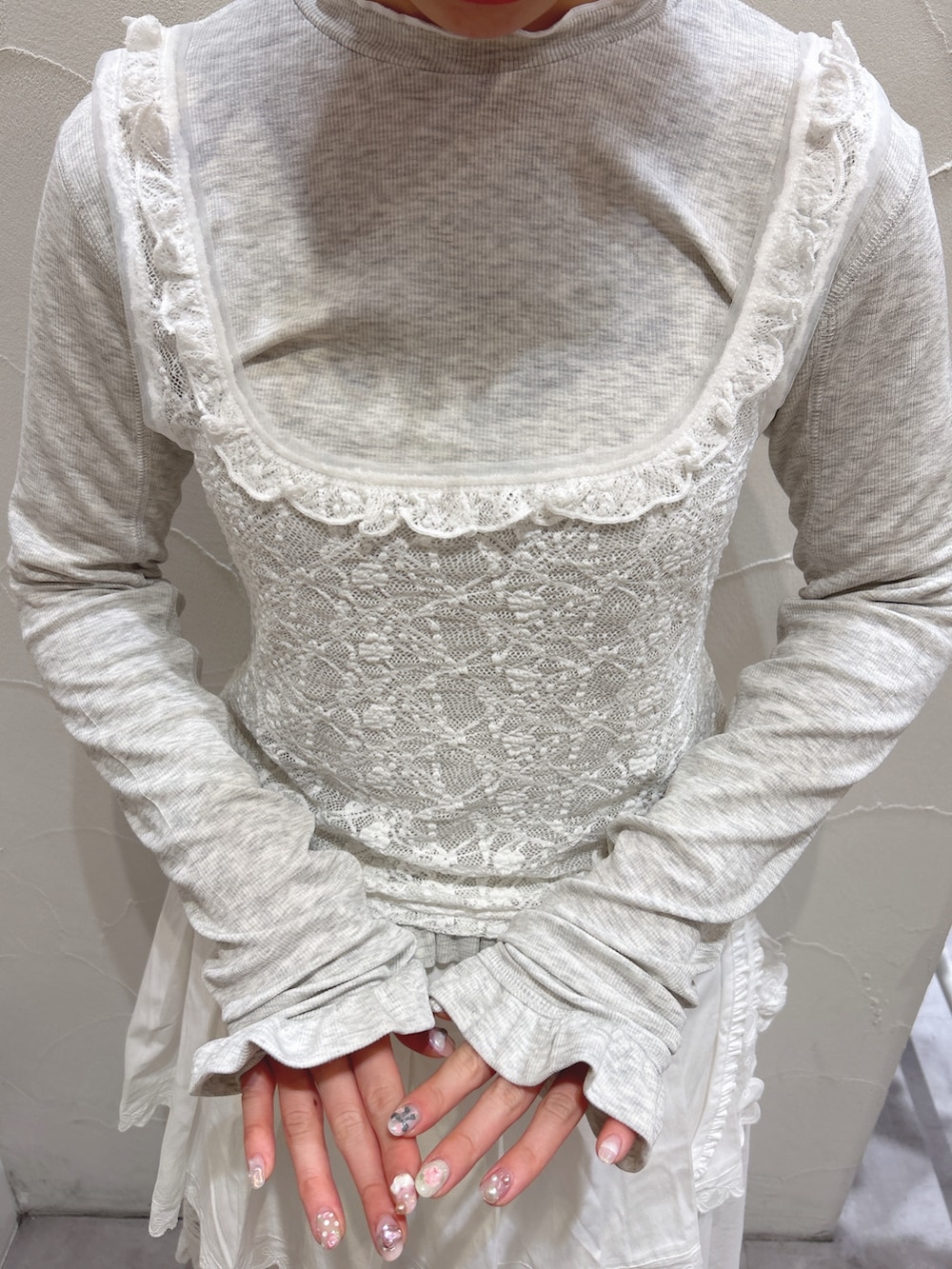 グレー系のTシャツ/カットソー、ホワイト系のスカート、ホワイト系のスニーカーを着用したレディースの冬コーディネートの8枚目の写真