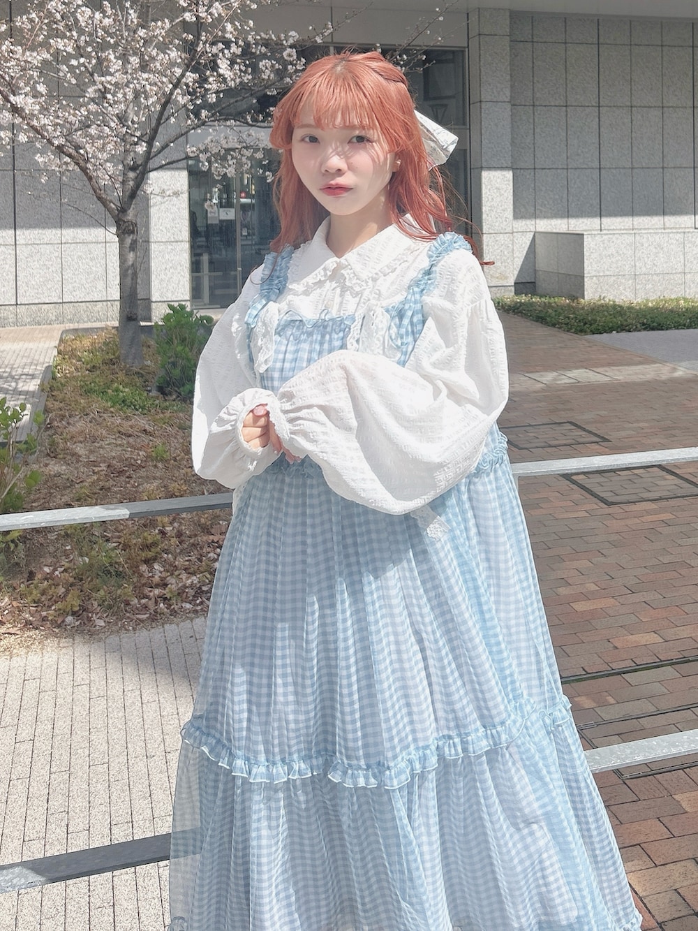 ブルー系のワンピース、ホワイト系のシャツ/ブラウス、ホワイト系のスニーカーを着用したレディースの春コーディネートの6枚目の写真