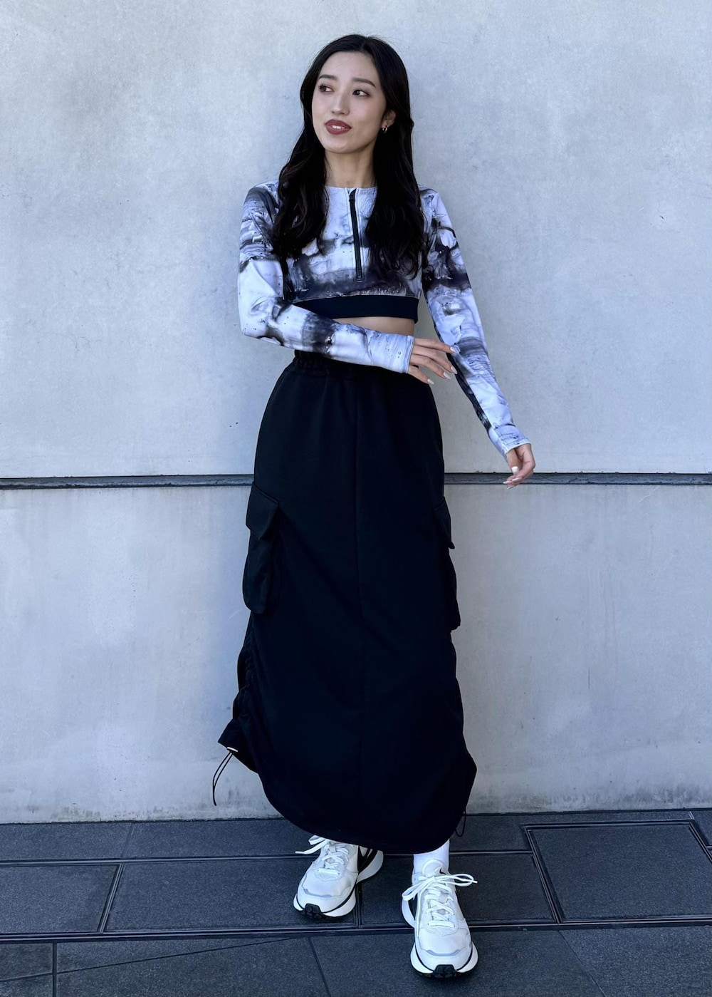 ブラック系のブルゾン、ブラック系のスカート、ホワイト系のスニーカーを着用したレディースの冬コーディネートの3枚目の写真