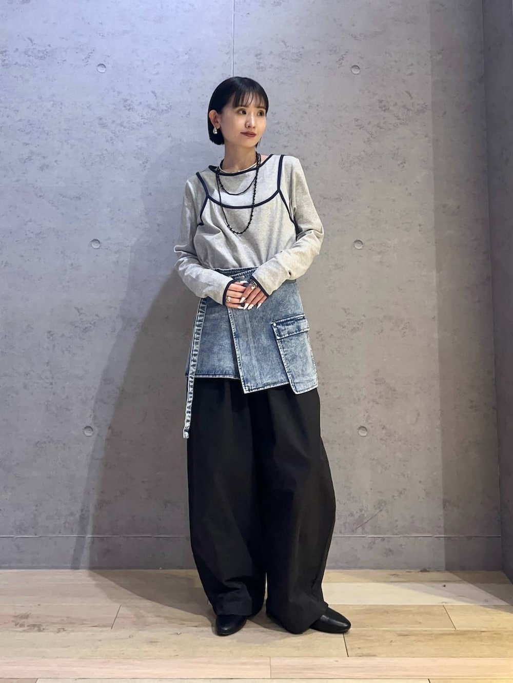 ブルー系のシャツ/ブラウス、グレー系のTシャツ/カットソー、ブラック系のボストンバッグを着用したレディースの春コーディネートの4枚目の写真