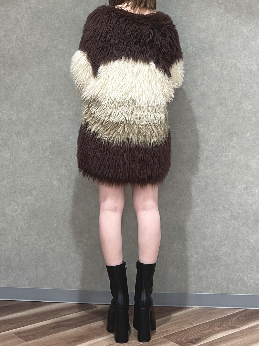 ベージュ系のワンピース、その他のカーディガン/ボレロ、ブラック系のブーツを着用したレディースの秋コーディネートの3枚目の写真