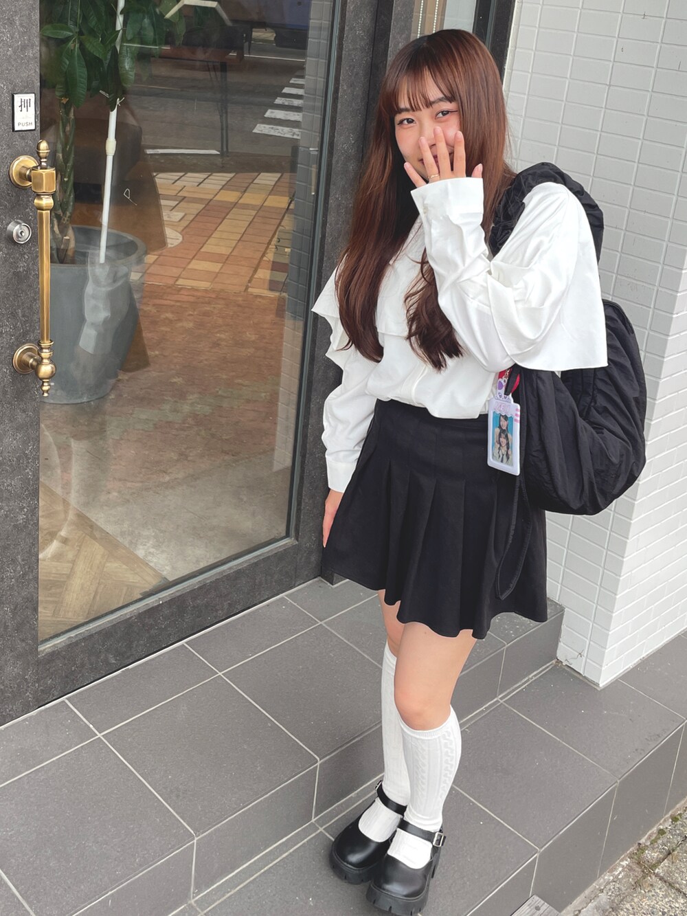 ホワイト系のシャツ/ブラウス、ブラック系のバッグ、ブラック系のスカートを着用したレディースの秋コーディネートの2枚目の写真