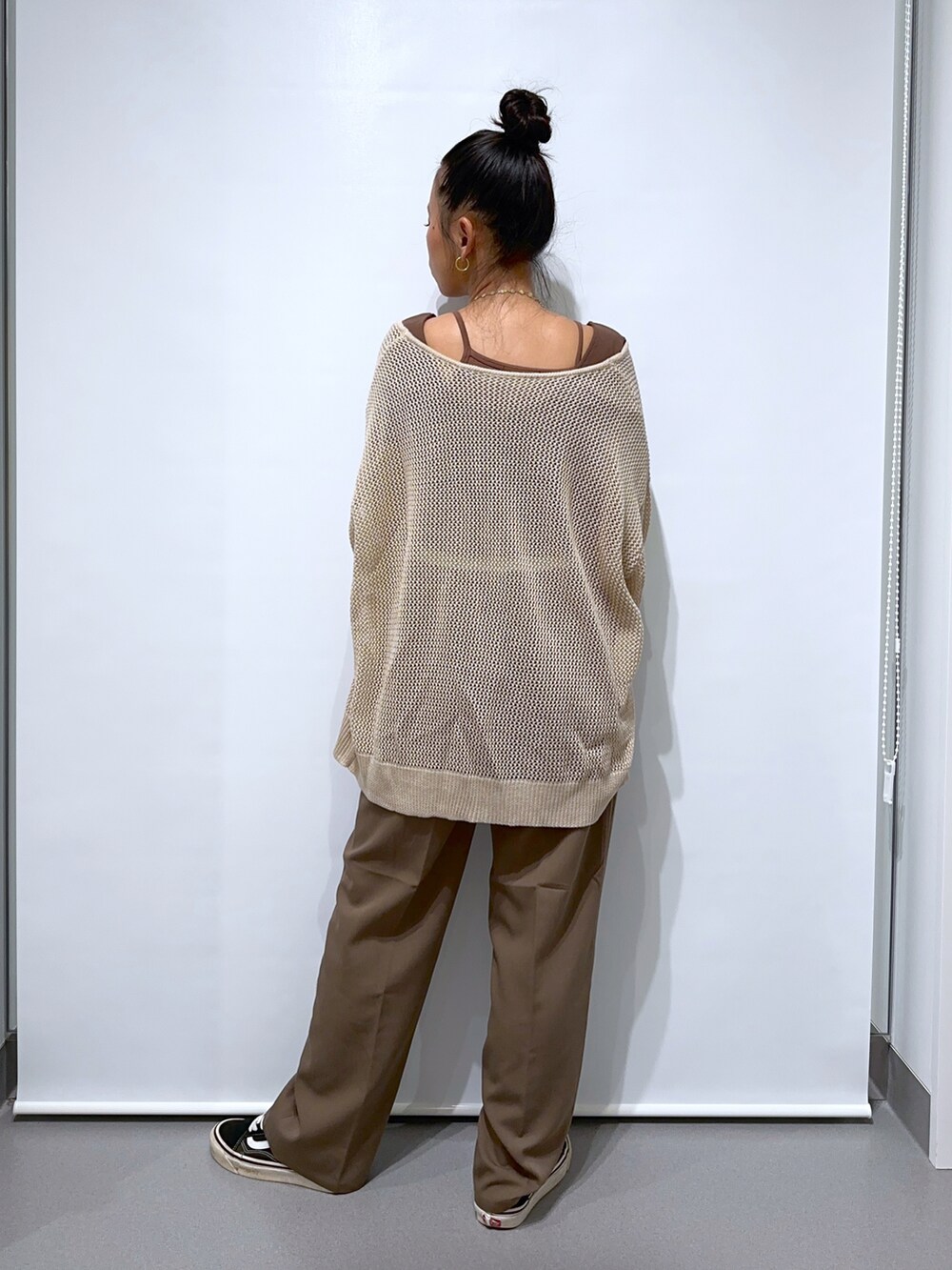 ブラック系のスニーカー、ブラウン系のスラックス、ブラウン系のTシャツ/カットソーを着用したレディースの夏コーディネートの3枚目の写真