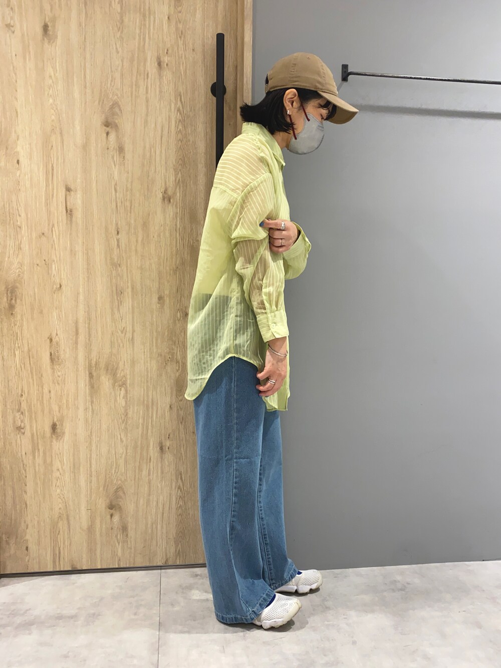 グリーン系のシャツ/ブラウス、ブルー系のデニムパンツ、ホワイト系のサンダルを着用したレディースの春コーディネートの2枚目の写真