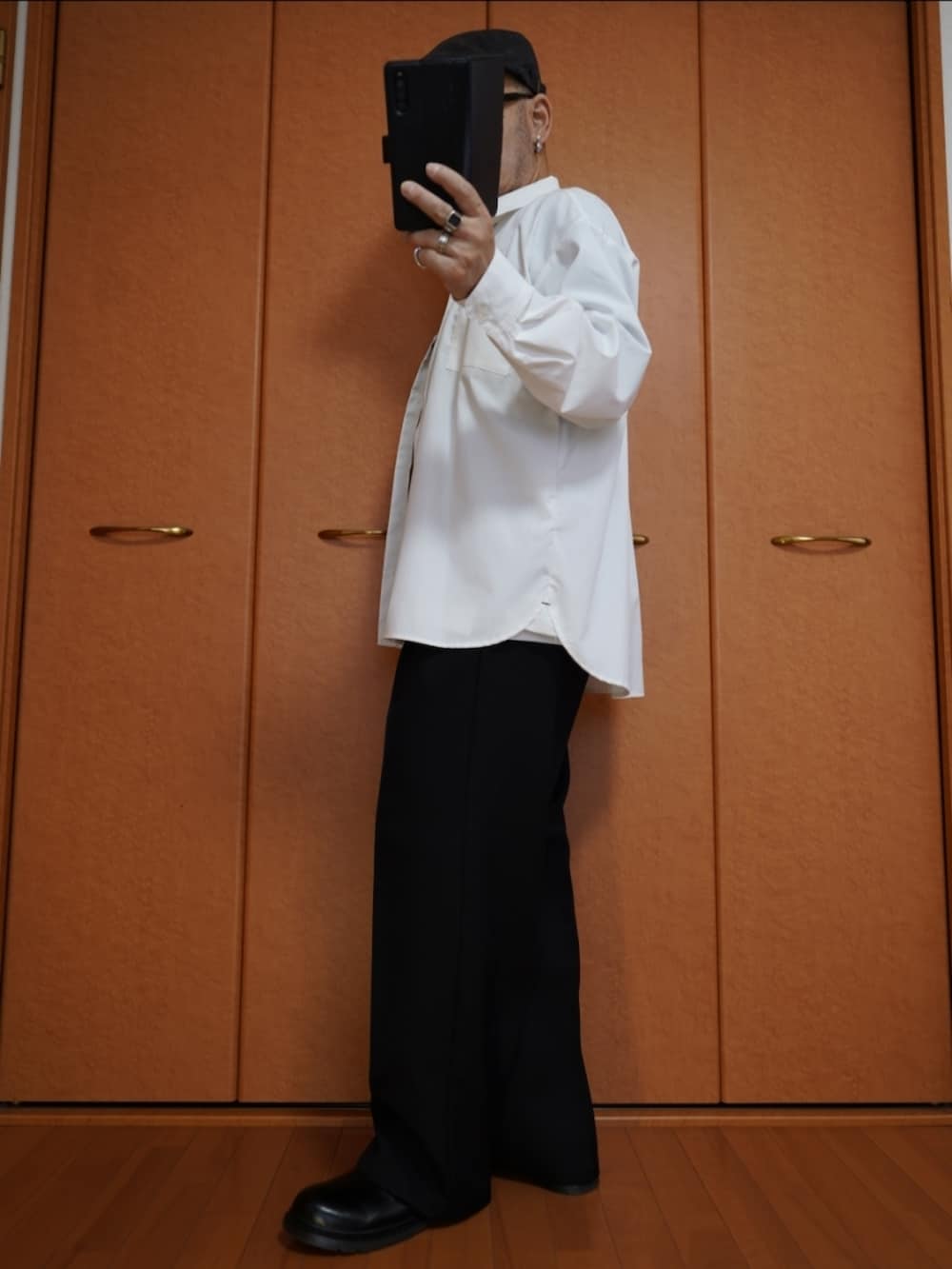 ブラック系のパンツ、ホワイト系のシャツ/ブラウス、ブラック系のシューズを着用したメンズの秋コーディネートの2枚目の写真