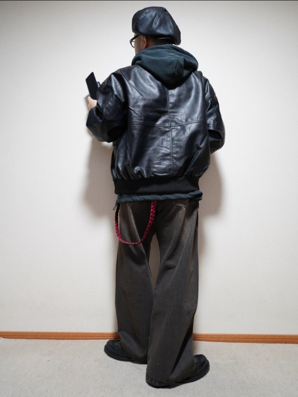 ブラック系のシューズ、ブラック系のデニムパンツ、ブラック系のパーカーを着用したメンズの冬コーディネートの4枚目の写真