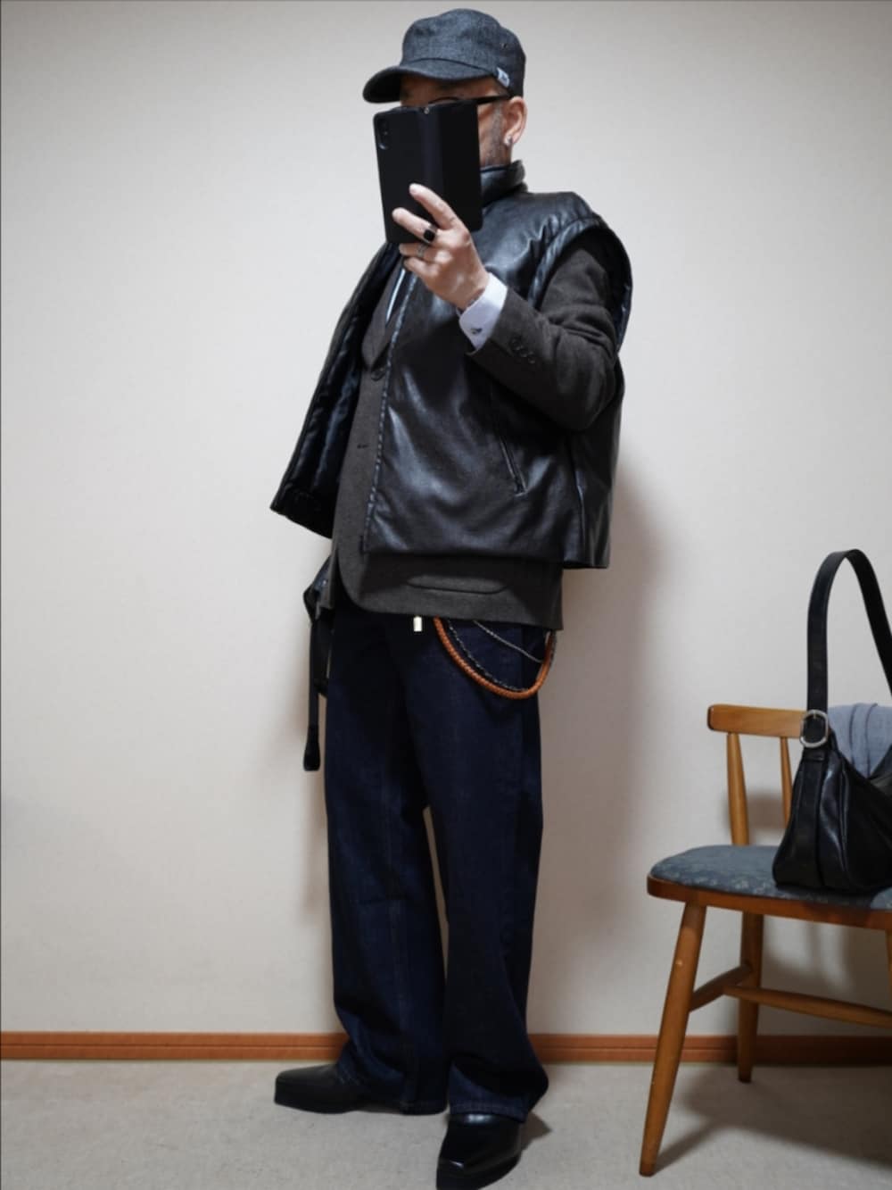 ブラック系のブーツ、ブルー系のデニムパンツ、ブラウン系のテーラードジャケットを着用したメンズの春コーディネートの2枚目の写真