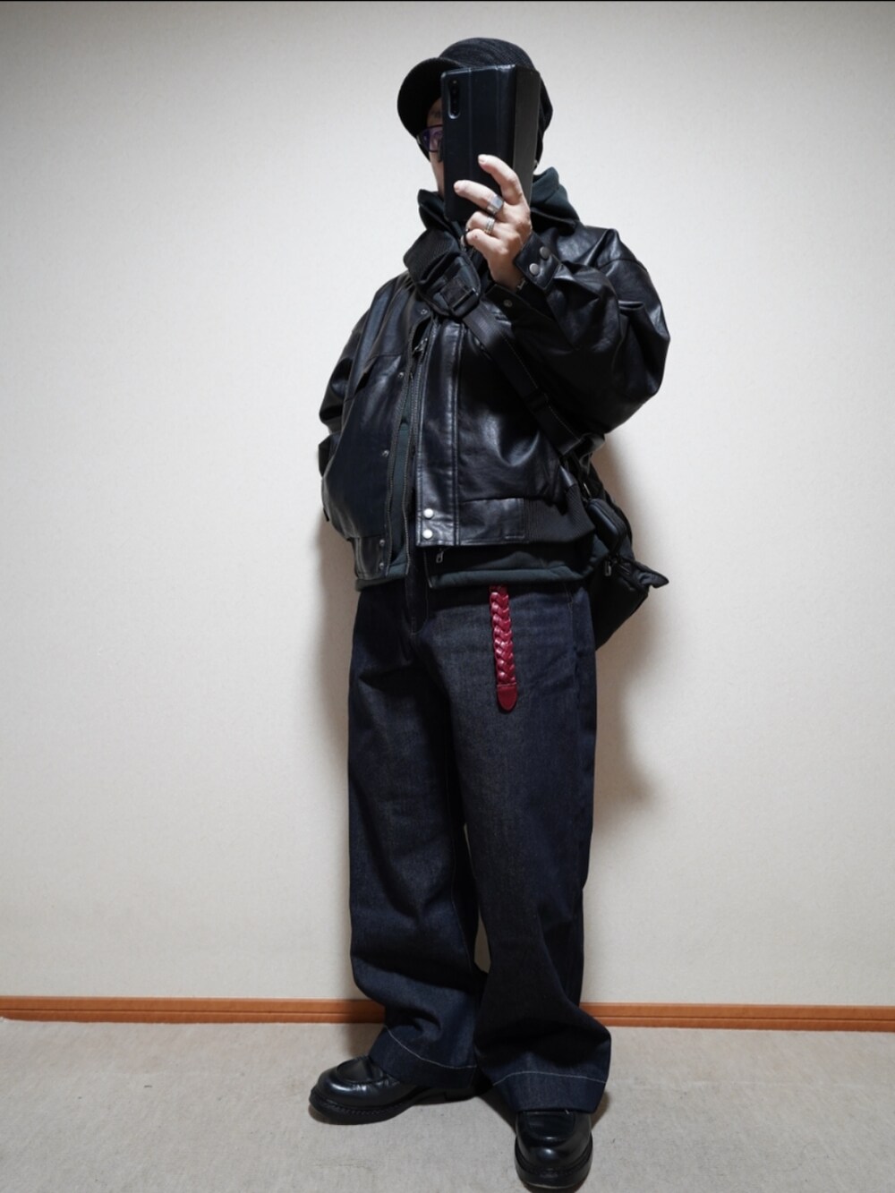 ブラック系のシューズ、ブルー系のデニムパンツ、ブラック系のパーカーを着用したメンズの冬コーディネートの4枚目の写真